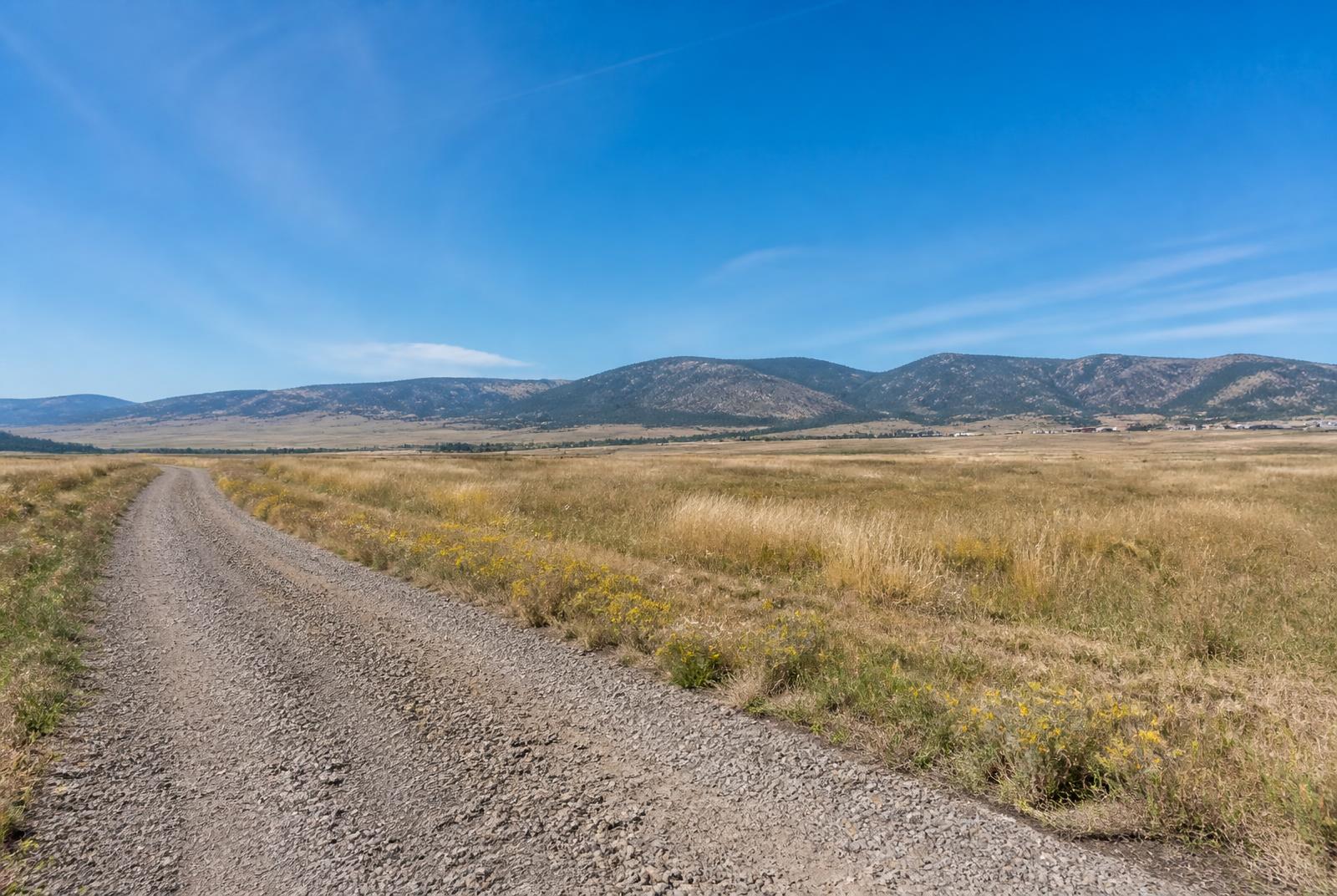 Undeveloped residential homesite with gravel access road in Laramie County, Wyoming